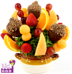 Fresh fruit bouquet with chocolate covered pineapple slices in an acorn design topped with toffee