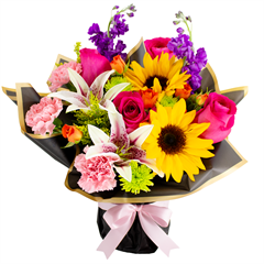 Vibrant Charm Bouquet includes roses, lilies and more in a buchon style bouquet